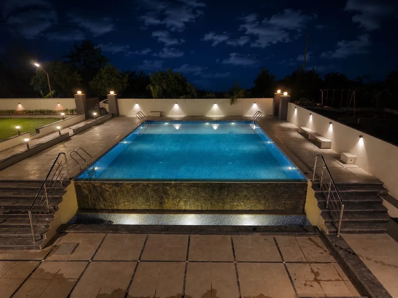 Pool lit up at night at Red farm ridge, Keesara